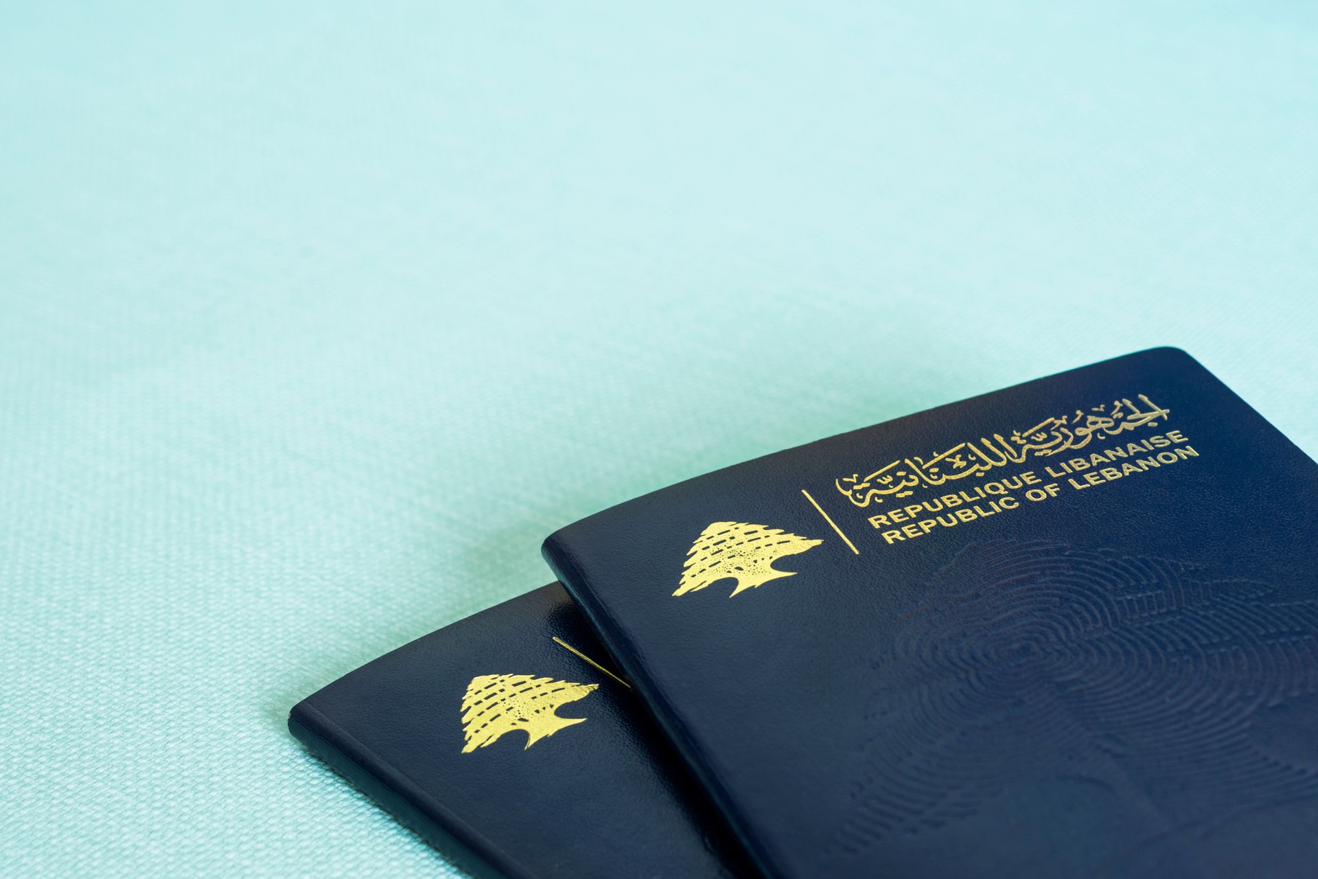 Two Lebanese passports on blue background
